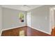 Bright bedroom featuring gleaming hardwood floors, natural light, and a ceiling fan for added comfort at 9055 Glass Chimney Ln, Fishers, IN 46037