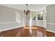 Bright dining room with bay window, chandelier, hardwood floors, and neutral paint at 9055 Glass Chimney Ln, Fishers, IN 46037