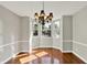 Bright dining room with bay window, hardwood floors, neutral paint, and modern chandelier at 9055 Glass Chimney Ln, Fishers, IN 46037