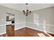 Inviting dining area with hardwood floors, modern chandelier, and seamless transition to the kitchen at 9055 Glass Chimney Ln, Fishers, IN 46037