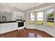 Cozy kitchen with a bay window, granite countertops, white cabinets, and modern appliances at 9055 Glass Chimney Ln, Fishers, IN 46037