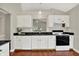 Kitchen boasts white cabinets, black countertops, and modern appliances at 9055 Glass Chimney Ln, Fishers, IN 46037