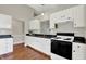 A kitchen showcases white cabinets, black countertops, and modern appliances at 9055 Glass Chimney Ln, Fishers, IN 46037
