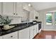 The kitchen features white cabinets, black countertops, and modern appliances at 9055 Glass Chimney Ln, Fishers, IN 46037