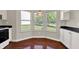 Eat-in kitchen features a bay window and white cabinets at 9055 Glass Chimney Ln, Fishers, IN 46037