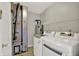 Laundry room featuring modern washer and dryer units, water heater, and storage shelves for convenience at 9055 Glass Chimney Ln, Fishers, IN 46037