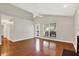 Bright living room with hardwood floors, white trim, and access to outdoor deck at 9055 Glass Chimney Ln, Fishers, IN 46037