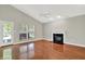 Living room with wood floors, fireplace, and a door to the backyard at 9055 Glass Chimney Ln, Fishers, IN 46037