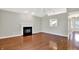 Bright living room with hardwood floors, neutral paint, and a fireplace at 9055 Glass Chimney Ln, Fishers, IN 46037