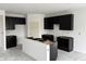 Modern kitchen with sleek black cabinets and a white island, ready for customization and appliances at 9125 Steinbeck Ln, Indianapolis, IN 46239