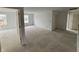 Open-concept living room with natural light, featuring doorways and a view to the exterior at 9125 Steinbeck Ln, Indianapolis, IN 46239