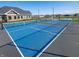 Tennis court with a black fence surround, adjacent to green space, with houses in the background at 9125 Steinbeck Ln, Indianapolis, IN 46239