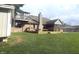 Spacious backyard with green lawn, deck, mature trees, and patio at 920 Corey Ln, Plainfield, IN 46168