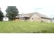 Expansive backyard featuring a well-maintained lawn, patio, shed, and mature trees at 920 Corey Ln, Plainfield, IN 46168