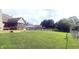 Large, fenced backyard with deck and a lush green lawn; ideal for outdoor activities at 920 Corey Ln, Plainfield, IN 46168