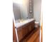 Bathroom featuring light blue walls, stained cabinets and laminate floors at 920 Corey Ln, Plainfield, IN 46168