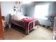 Bedroom with light blue walls, natural light and a large window with a comfortable bed at 920 Corey Ln, Plainfield, IN 46168