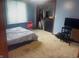Cozy bedroom with neutral carpet, closet, and window; furnished with bed and TV stand at 920 Corey Ln, Plainfield, IN 46168