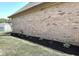 Side exterior wall with neatly lined landscaping and mulch adding a touch of elegance to the property at 920 Corey Ln, Plainfield, IN 46168