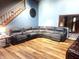 Open living room with laminate floors, large sectional sofa, and tall ceilings at 920 Corey Ln, Plainfield, IN 46168