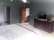 Spacious bedroom with a large bed, dark paint, and ample closet space at 920 Corey Ln, Plainfield, IN 46168