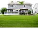 Large, well-manicured backyard with a deck, gazebo, fire pit, and a lush lawn at 10113 Gallop Ln, Fishers, IN 46040
