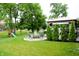 Expansive backyard featuring a covered patio with a grill, a firepit, and playground equipment, perfect for outdoor enjoyment at 10113 Gallop Ln, Fishers, IN 46040