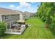 Expansive backyard featuring a wooden deck, gazebo, fire pit, playground, and lush green lawn at 10113 Gallop Ln, Fishers, IN 46040