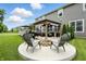 Backyard patio with a fire pit area, an outdoor kitchen under a pergola, and lush green lawn at 10113 Gallop Ln, Fishers, IN 46040