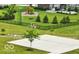 A backyard basketball court with a hoop, concrete surface, surrounded by a lush lawn and landscaping at 10113 Gallop Ln, Fishers, IN 46040