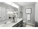 Well-lit bathroom featuring a double vanity, granite countertops, decorative wall art and neutral gray paint at 10113 Gallop Ln, Fishers, IN 46040