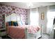 Charming bedroom with floral wallpaper, a decorative chandelier, and plenty of natural light at 10113 Gallop Ln, Fishers, IN 46040