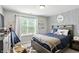 bedroom with dark bedframe and decor with tepee tent, blue accents, and patterned wallpaper at 10113 Gallop Ln, Fishers, IN 46040