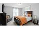 Cozy bedroom with a dark wood bed frame, light gray walls, and neutral accents offers a tranquil space at 10113 Gallop Ln, Fishers, IN 46040