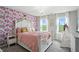 Charming bedroom features a floral wallpaper accent wall, and a white canopy bed at 10113 Gallop Ln, Fishers, IN 46040