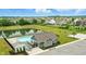 Aerial view of a community pool area with a pool house, pond, and surrounding residential neighborhood at 10113 Gallop Ln, Fishers, IN 46040