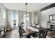 Elegant dining room featuring a large table, stylish chandelier, and ample natural light from the window at 10113 Gallop Ln, Fishers, IN 46040
