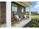 Inviting front porch with comfortable rocking chairs, potted plants, and decorative pillows at 10113 Gallop Ln, Fishers, IN 46040