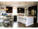 Modern kitchen featuring stainless steel appliances, dark cabinets, a white island, and pendant lighting at 10113 Gallop Ln, Fishers, IN 46040