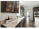 Kitchen features granite countertops, stainless steel appliances, a subway tile backsplash, and modern dark cabinets at 10113 Gallop Ln, Fishers, IN 46040
