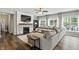 Cozy living room with a stone fireplace, large sectional sofa, and bright natural light at 10113 Gallop Ln, Fishers, IN 46040
