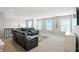 Upstairs living room with comfortable leather seating, neutral walls, and natural light creates a relaxing atmosphere at 10113 Gallop Ln, Fishers, IN 46040