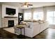 Comfortable living room featuring a stone fireplace, a large sectional sofa, and plenty of natural light at 10113 Gallop Ln, Fishers, IN 46040