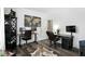 Spacious home office with two desks, modern decor, and a faux cowhide rug creates a functional workspace at 10113 Gallop Ln, Fishers, IN 46040