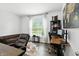 Stylish office features an accent wall, a cowhide rug, a dark wood desk, and a comfortable sofa at 10113 Gallop Ln, Fishers, IN 46040