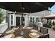 Outdoor dining setup on a wooden deck, complete with a table, chairs, umbrella, and place settings at 10113 Gallop Ln, Fishers, IN 46040