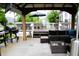 Patio featuring a built-in outdoor kitchen, shaded seating, and a grill, ideal for outdoor entertainment at 10113 Gallop Ln, Fishers, IN 46040
