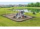 A vibrant neighborhood playground with slides, swings, climbing structures, and benches by the community lake at 10113 Gallop Ln, Fishers, IN 46040