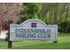 Close-up of an Indianapolis Sailing Club sign, nestled in a lush green lawn with flowering trees in the background at 10113 Gallop Ln, Fishers, IN 46040