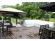 Backyard entertainment area with a grill, a firepit, wood decking, and outdoor seating at 10113 Gallop Ln, Fortville, IN 46040